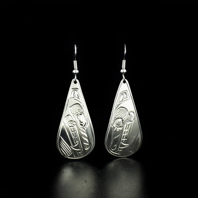Teardrop wolf earrings hand-carved by Heiltsuk artist Ivan Wilson. Made of sterling silver. Each earring measures 2.30" x 0.80" including hook.
