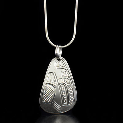 Teardrop wolf pendant hand-carved by Heiltsuk artist Ivan Wilson. Made of sterling silver. Pendant measures 1.65" x 0.90" including bail. Chain not included.