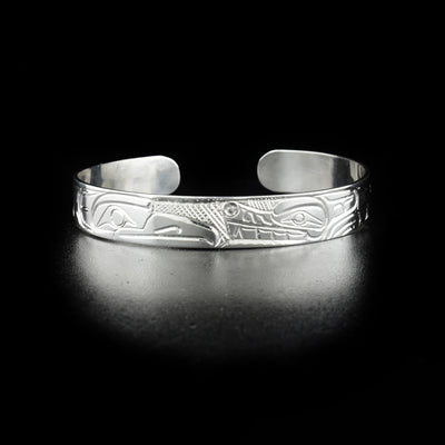 Wolf and raven bracelet hand-carved by Kwakwaka'wakw artist Norman Seaweed. Made of sterling silver. Bracelet is 6.30" long with 0.40" gap and has width of 0.38".