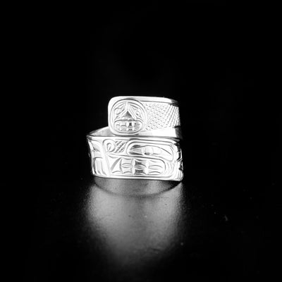 Sterling silver wolf wrap ring hand-carved by Coast Salish and Cree artist Richard Lang. Ring depicts a wolf below the moon. Band is 0.38" wide, with the flexible wrap design giving the ring a comfortable fit. Size 11.5.