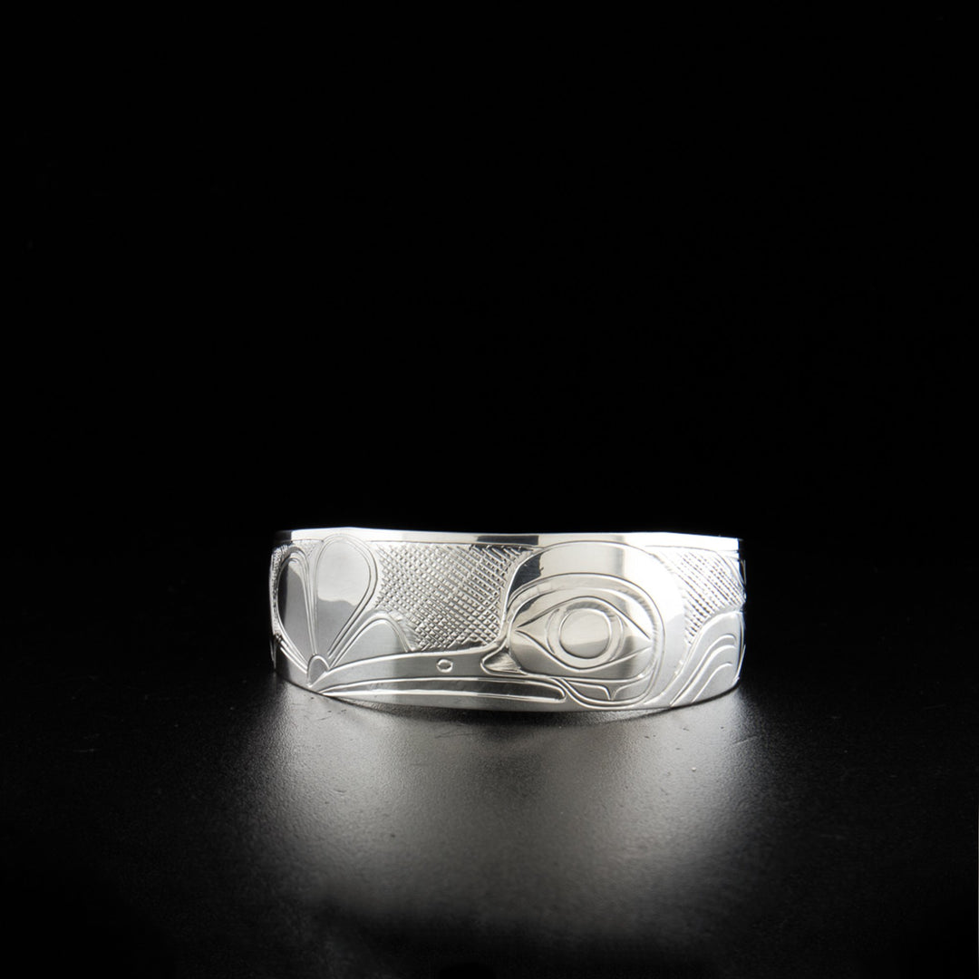 Sterling silver hummingbird bracelet hand-carved by Kwakwaka'wakw artist Don Lancaster. 6.19" long with 0.69" gap. 0.75" wide with tapered ends.