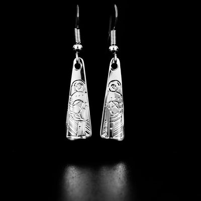 Sterling Silver Triangle Hummingbird Earrings by Jeffrey Pat. Each earring is in the shape of a triangle. The artist has hand-carved the profile of a hummingbird's head in each earring at the bottom. Each hummingbird has a small feather on the back of its head and a long, narrow beak pointing downwards.