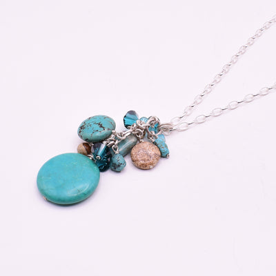 Turquoise, Jasper and Crystal Cluster Pendant Necklace handcrafted by artist Karley Smith. Pendant made of turquoise, Swarovski Crystal, sterling silver and jasper. Sterling silver chain included. Pendant measures 2.55" x 1" including bail and chain is 30" long.