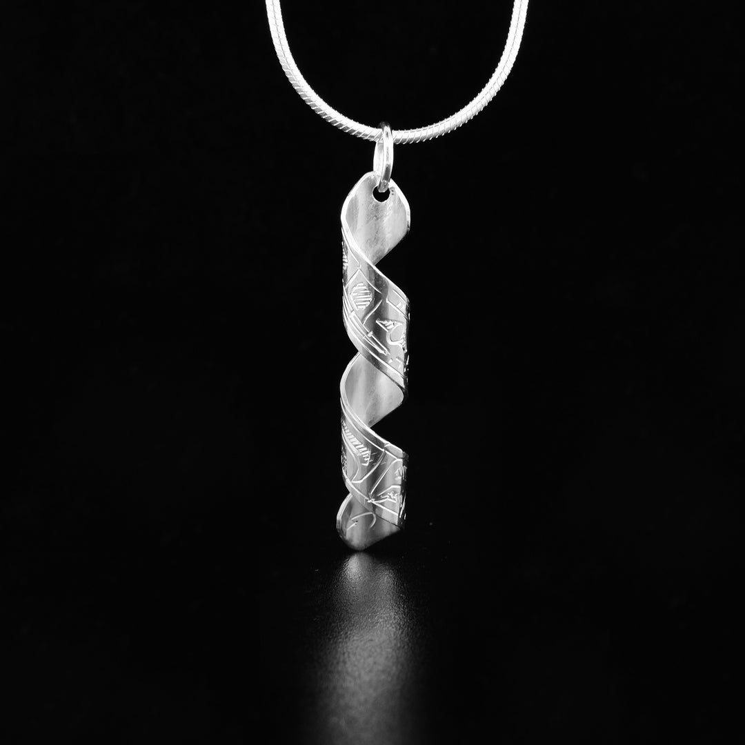 This Vertical Twist Wolf Pendant is hand-carved by Coast Salish artist Gilbert Pat. He has used sterling silver to create this piece. The pendant measures 1.50" x 0.25" including the bail. The chain is not included. The Wolf Legend Represents: LOYALTY, TEACHER, COOPERATION.