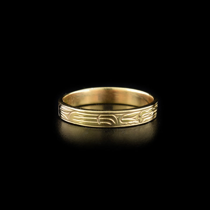 Left angle photo of the gold ring depicts carved designs depicting the wolf's other paw.