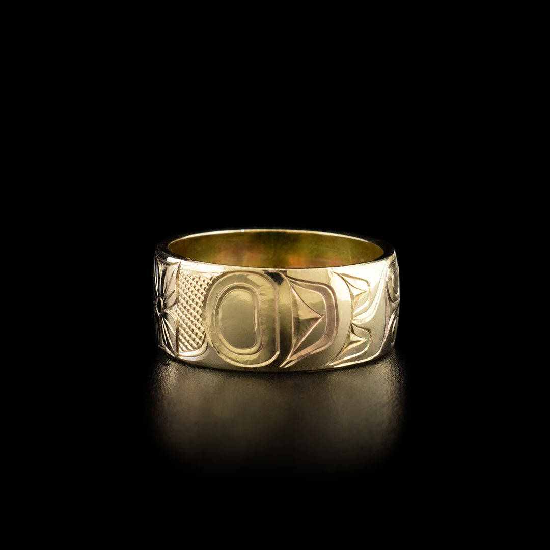 Right angle photo of the ring shows carved designs representing the body of the hummingbird.