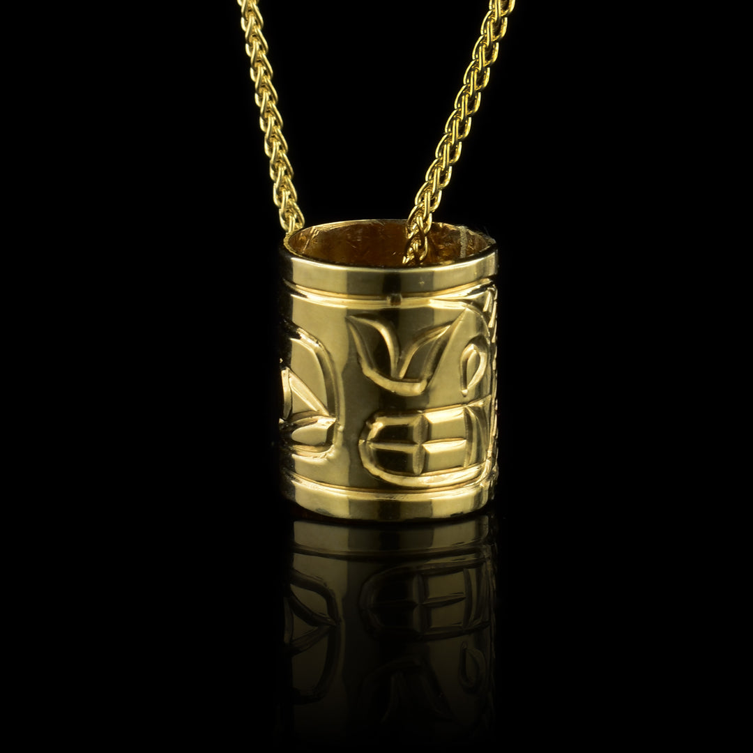 This 10K gold Orca charm is a long, cylinder bead that has the head of the Orca carved into it.
