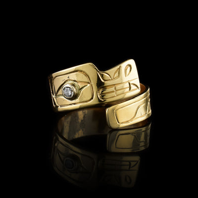 These 14K gold lab grown diamond ring has a single band that wraps around the finger twice.The band is shaped like the head of the Wolf and there are carvings across the surface of it depicting the legend. The head is shown at a side profile and there is a lab grown diamond embedded in the eye of the Wolf.