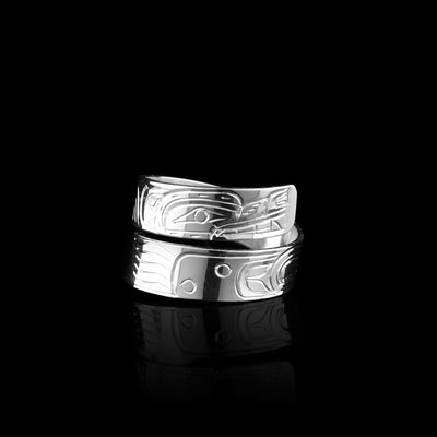 This sterling silver wrap ring has a thin, single band that wraps around the finger twice. There's a depiction of the Wolf legend carved into the surface of the piece. Its head is at the top of the band and the bottom one is the tail. The details of the face as well as the legs and tail are included.
