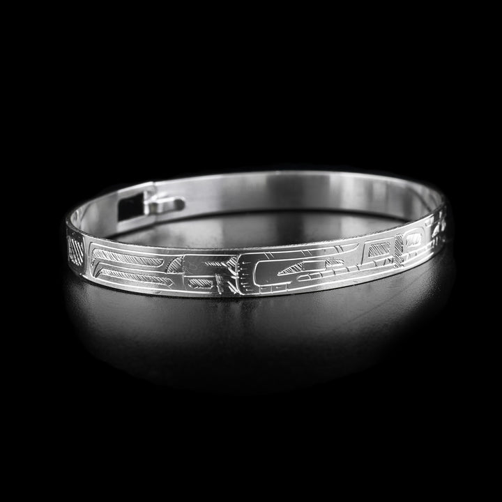 This Wolf and Bear bracelet has a thing, sterling silver band with a clasp in the back. There is a Wolf and a Bear legend carved into the band and their heads meet at the front of the piece. Their bodies extend around the rest of the band.