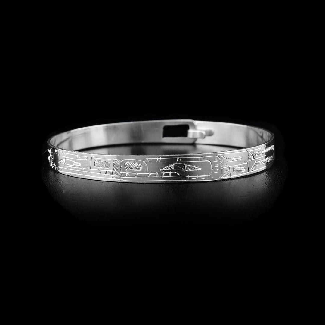 This Wolf and Bear bracelet has a thing, sterling silver band with a clasp in the back. There is a Wolf and a Bear legend carved into the band and their heads meet at the front of the piece. Their bodies extend around the rest of the band.