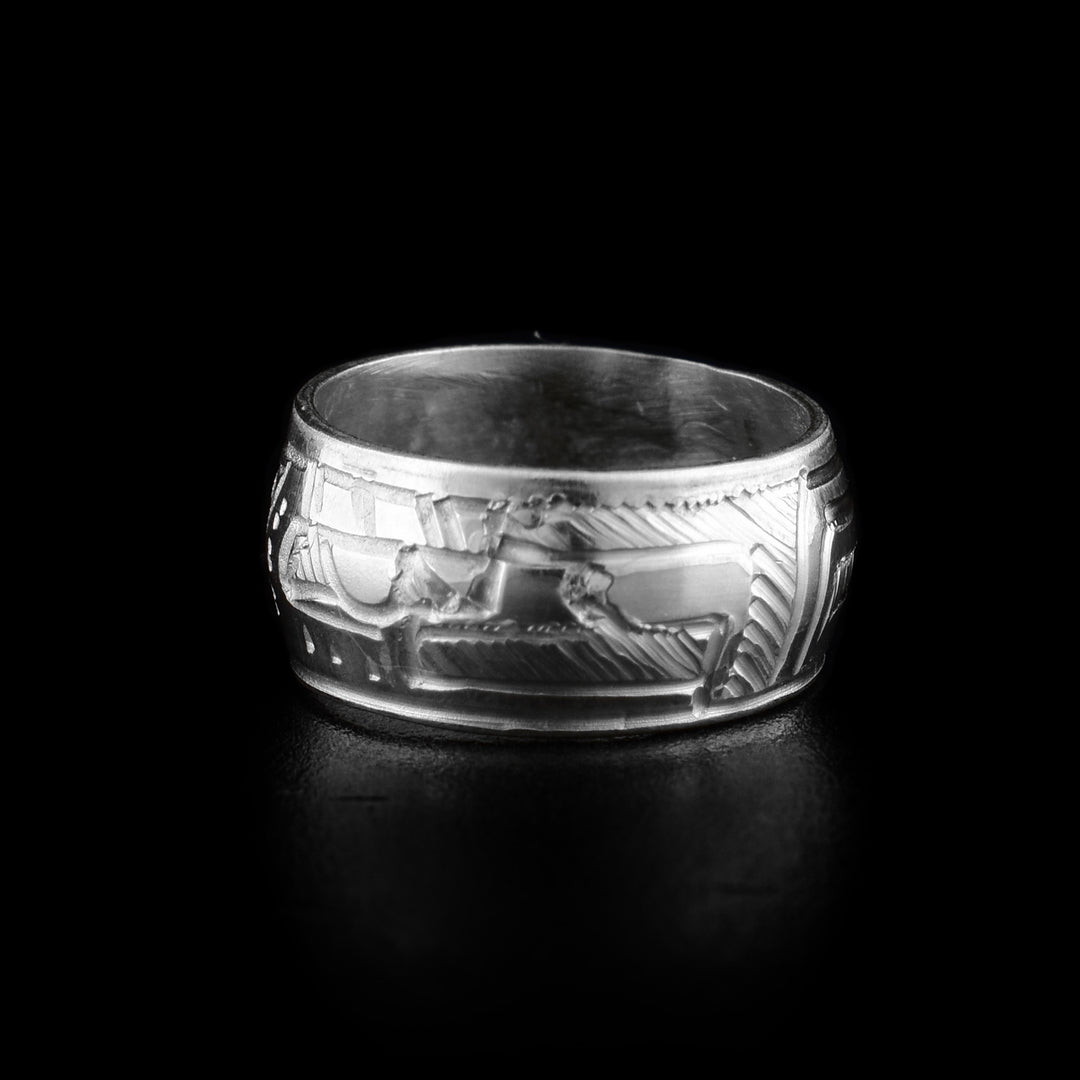 These bead charms are made from sterling silver and are round beads with a flat band. There is a depiction of the head of the Eagle carved around the piece with its beak, wing and eyes detailed.