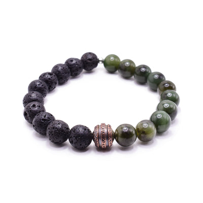 This lava rock bracelet has small, sphere beads made from black lava rocks and BC jade. Half of the piece is the lava rocks and the other half, the jade. There is a copper charm bead in the center of the piece with three textured bands on the surface of it.