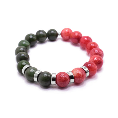 This red agate bracelet has small, sphere shaped beads made from BC jade and dyed red agate. Half the piece is jade and the other is agate. There are five rhodium plated spacers between the beads in the center of the piece. The spacers are round and flat.