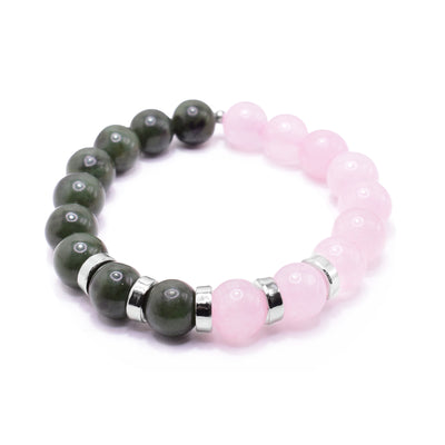 This pink quartz bracelet has small, sphere shaped beads made from BC jade and pink quartz. Half the piece is jade and the other is quartz. There are five rhodium plated spacers between the beads in the center of the piece. The spacers are round and flat.