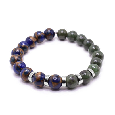 This jasper bracelet has small, sphere shaped beads made from BC jade and jasper. Half the piece is jade and the other is jasper which is purple and brown colored. There are five rhodium plated spacers between the beads in the center of the piece. The spacers are round and flat.