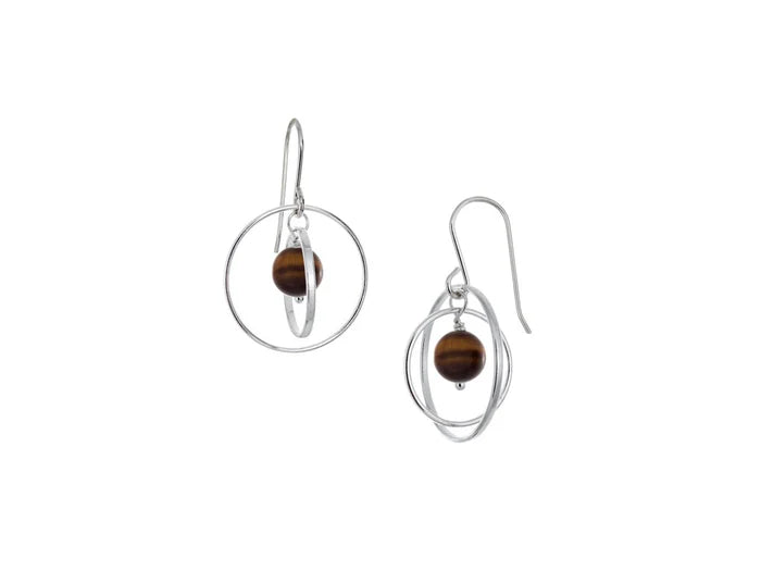 These hoop dangle earrings have large, sterling silver hoops with a smaller one inside of it. In the middle is a sphere shaped tiger's eye bead. All of these pieces are dangling and fit inside each other. The hoops are free to orbit around the gem.