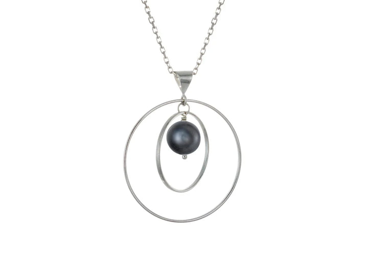 This black pearl necklace has a large sterling silver hoop with a smaller hoop in the middle of it and a sphere shaped black pearl bead in the center of them. All of these pieces are suspended and can orbit around each other.