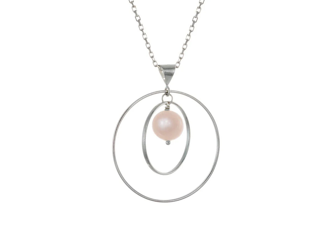 This pink pearl necklace has a large sterling silver hoop with a smaller hoop in the middle of it and a sphere shaped pink pearl bead in the center of them. All of these pieces are suspended and can orbit around each other.