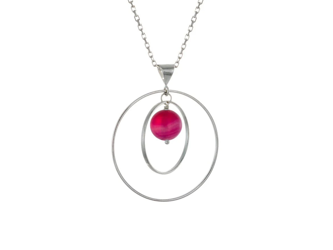 This pink agate necklace has a large sterling silver hoop with a smaller hoop in the middle of it and a sphere shaped pink agate bead in the center of them. All of these pieces are suspended and can orbit around each other.