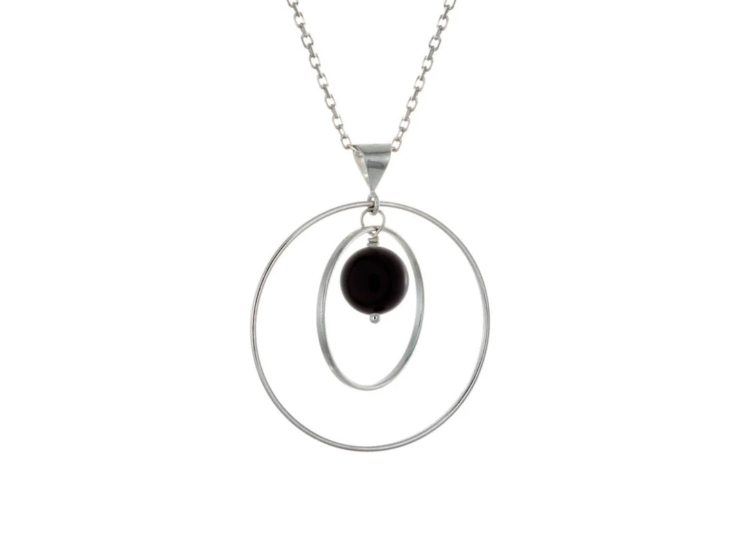 This black onyx necklace has a large sterling silver hoop with a smaller hoop in the middle of it and a sphere shaped black onyx bead in the center of them. All of these pieces are suspended and can orbit around each other.