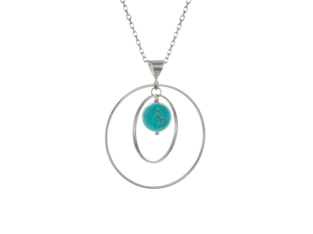 This turquoise necklace has a large sterling silver hoop with a smaller hoop in the middle of it and a sphere shaped turquoise bead in the center of them. All of these pieces are suspended and can orbit around each other.