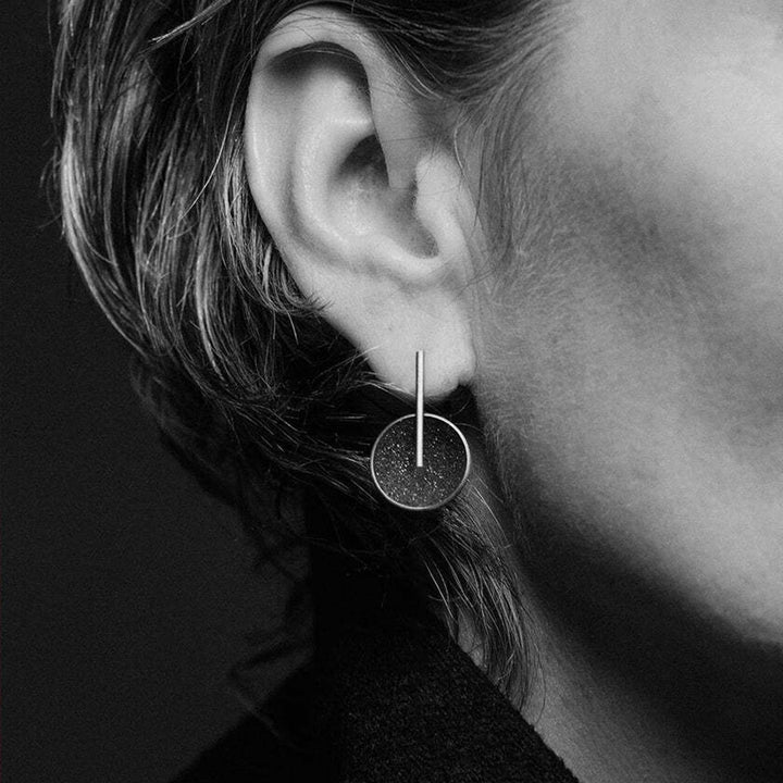 This photo depicts the stainless steel earrings on a female model.
