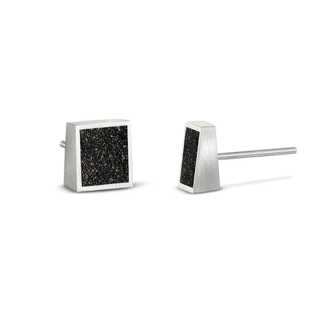 These stainless steel stud earrings are square in shape and feature a dark, shiny centerpiece made from concrete and diamond dust encased in a stainless steel border.