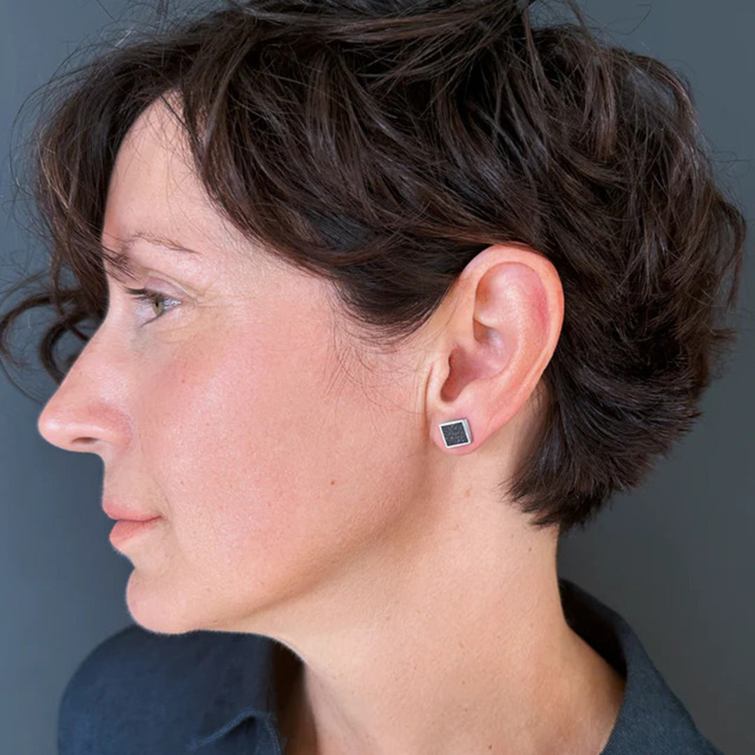 This picture shows the stainless steel stud earrings on a female model.