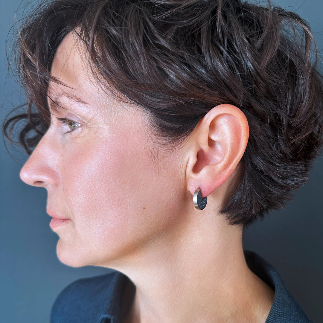 This photo shows the stainless steel stud earrings on a female model.
