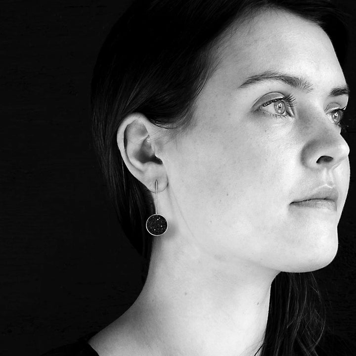 This photo shows the stainless steel earrings on a female model.