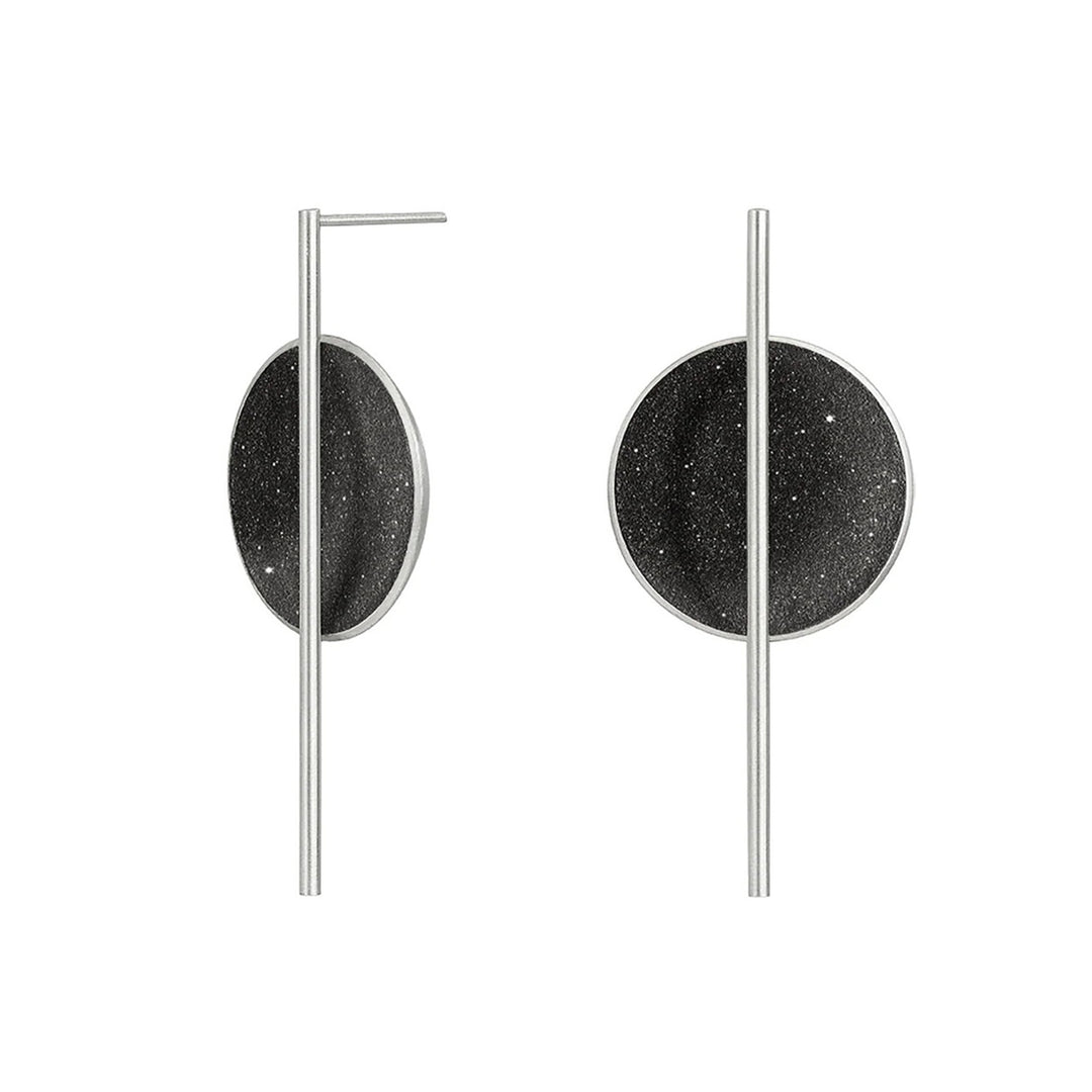 These stainless steel earrings have a long steel post connected to the front of a black-tinted, shiny circle.
