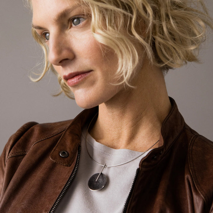 This photo shows the stainless steel necklace on a female model.