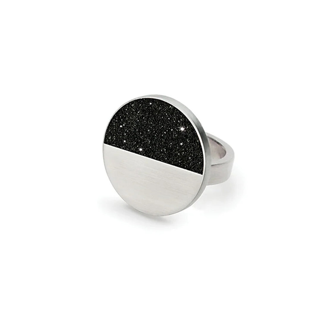 This stainless steel ring has a large, round centerpiece with the top half black and shiny and the bottom half stainless steel. The large centerpiece is connected to a sturdy steel band.