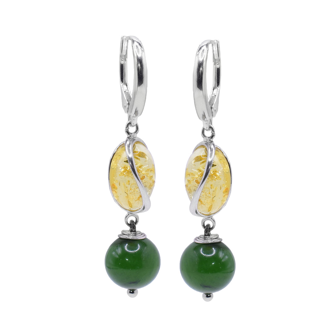These amber dangle earrings have oval shaped amber beads with a curvy sterling silver designs encasing it. below them, there are sphere shaped BC jade beads that are dangling.