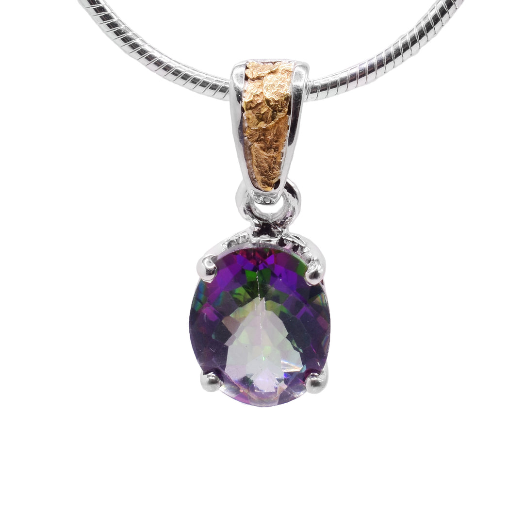 This blue topaz gold pendant is in the shape of an oval and has the colours green, purple, blue, and pink. The topaz is held in place by a sterling silver claw setting. The attached bail has 22k yellow gold nuggets on the front.