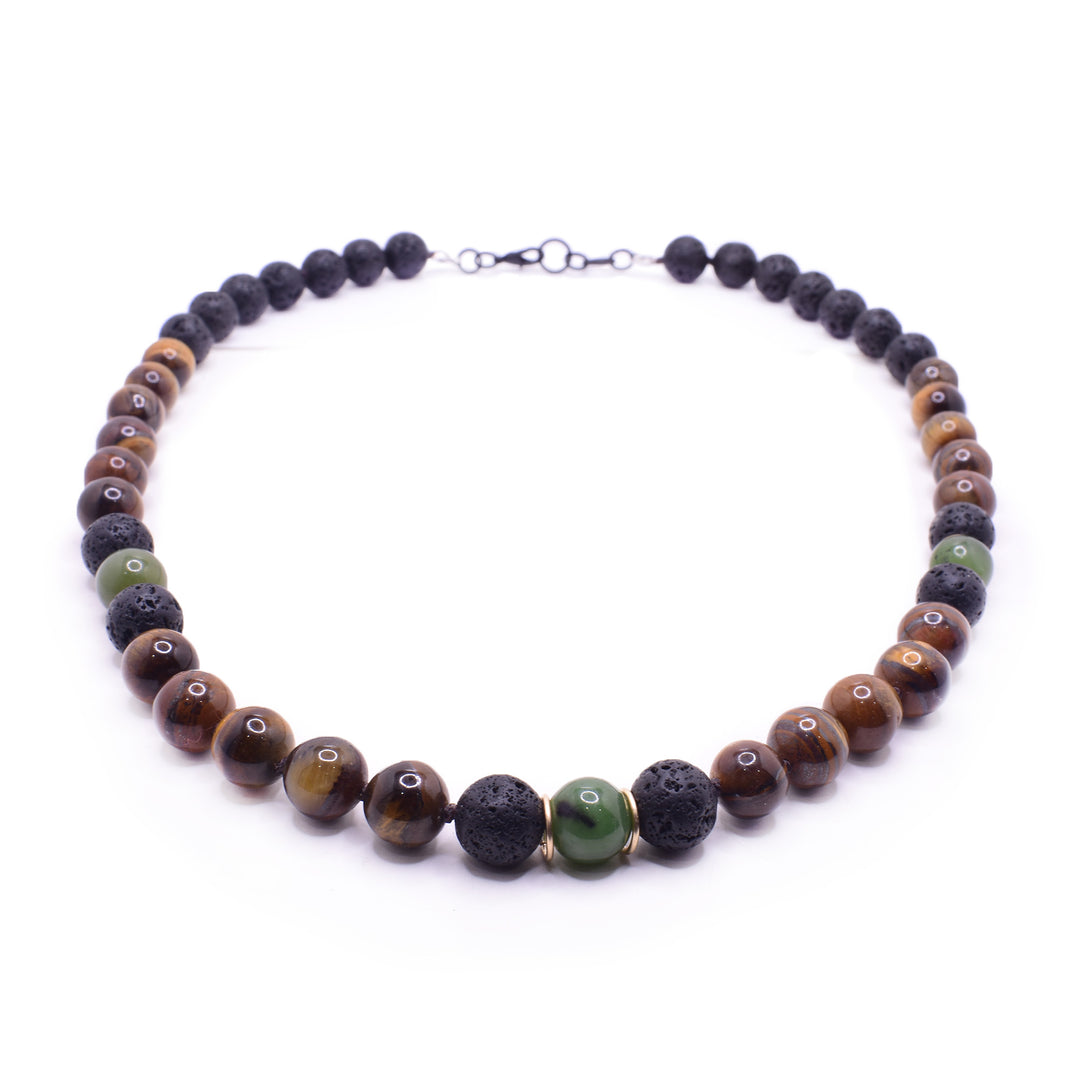 This beaded gemstone necklace has sphere shaped beads made from tiger's eye, lava rock and jade. There is lava rock in the back and tiger's eyes around the rest. There are jade and lava beads throughout as highlights. There are 14K gold filled hoops to either side of the jade bead in the center.