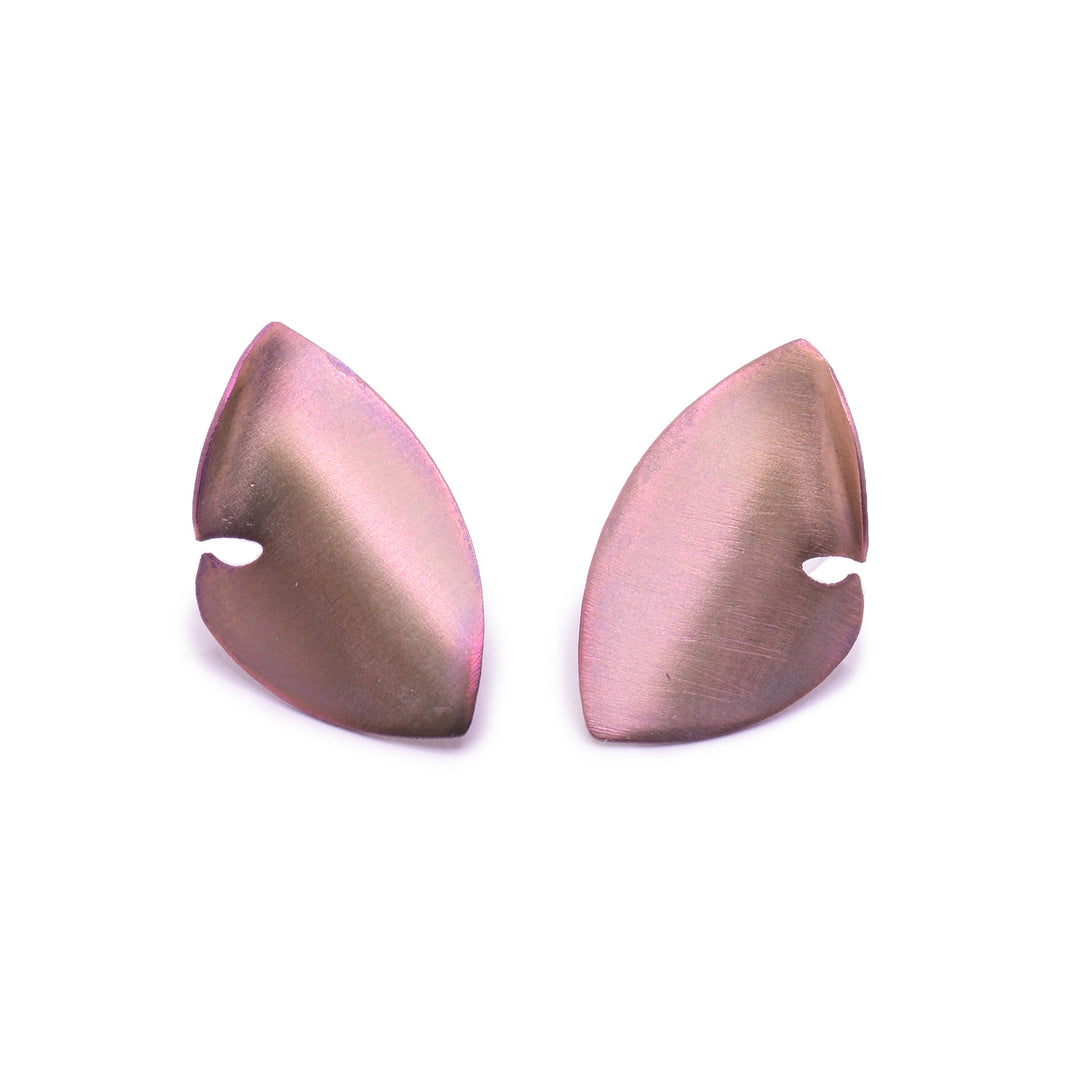 These titanium earrings studs are made from rose gold titanium and there are large and teardrop shaped. The studs curve to a point at both ends and there is a small cutout on the side of the studs.