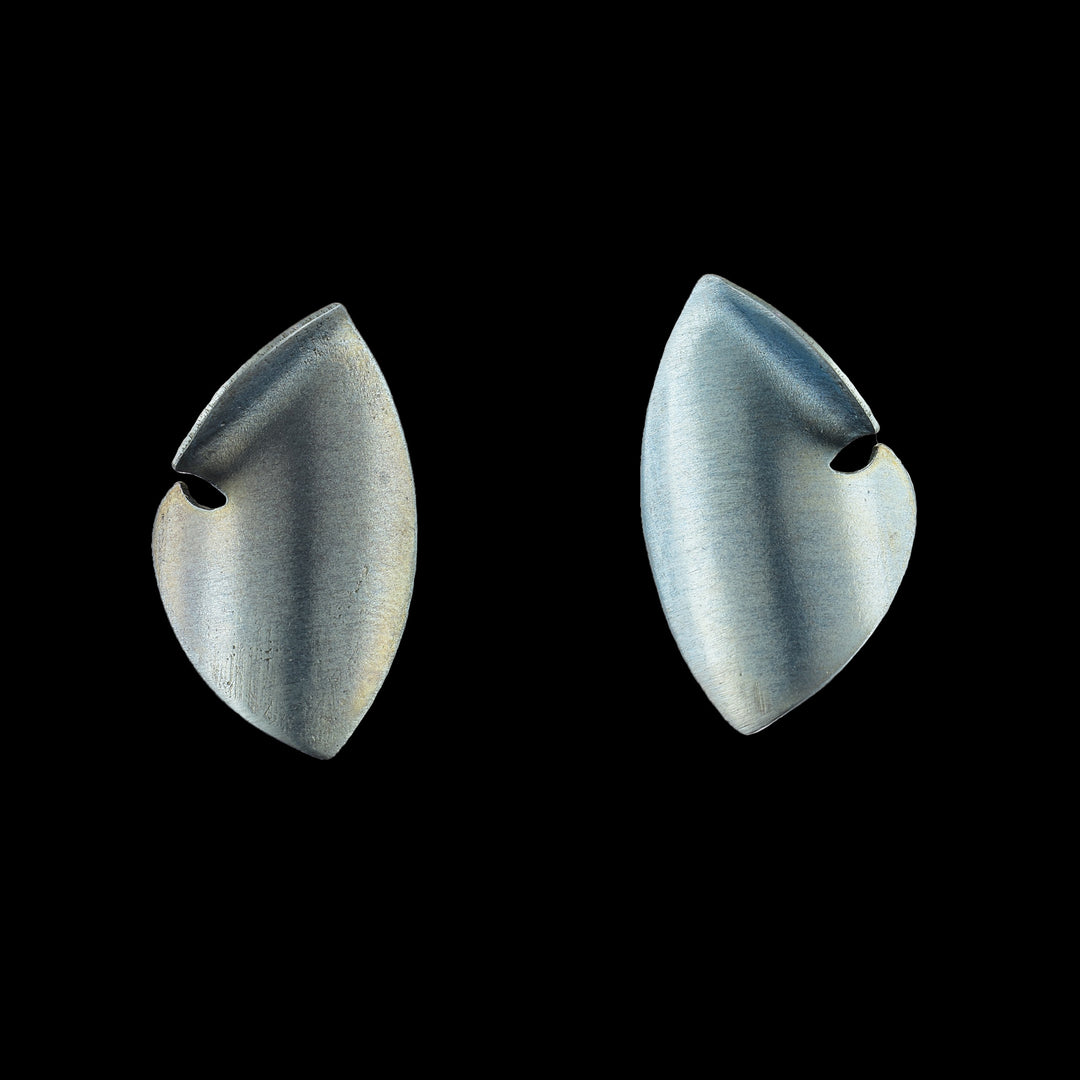 These titanium earrings studs are made from turquoise titanium and there are large and teardrop shaped. The studs curve to a point at both ends and there is a small cutout on the side of the studs.