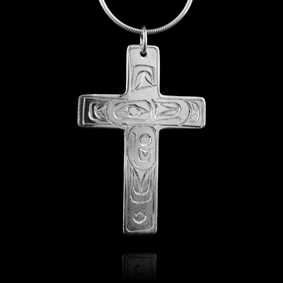 This mens cross pendant is made from sterling silver and is shaped like a christian cross. There are carvings on the surface with the head of the Eagle at a side profile in the center and feather like designs across the rest of the piece