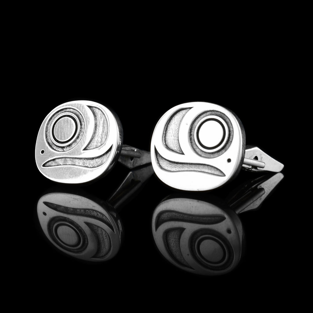 These sterling silver cuff links are circle shaped and have designs cast into them representing the egg of the Salmon. There is a circle design representing the embryo and wavy designs around it.