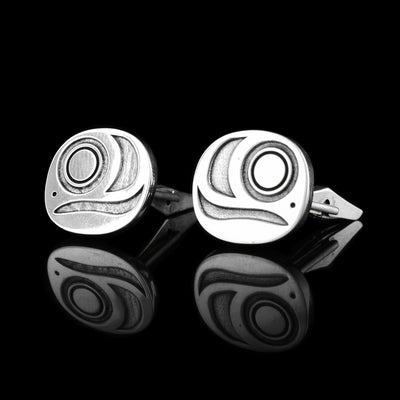 These sterling silver cuff links are circle shaped and have designs cast into them representing the egg of the Salmon. There is a circle design representing the embryo and wavy designs around it.