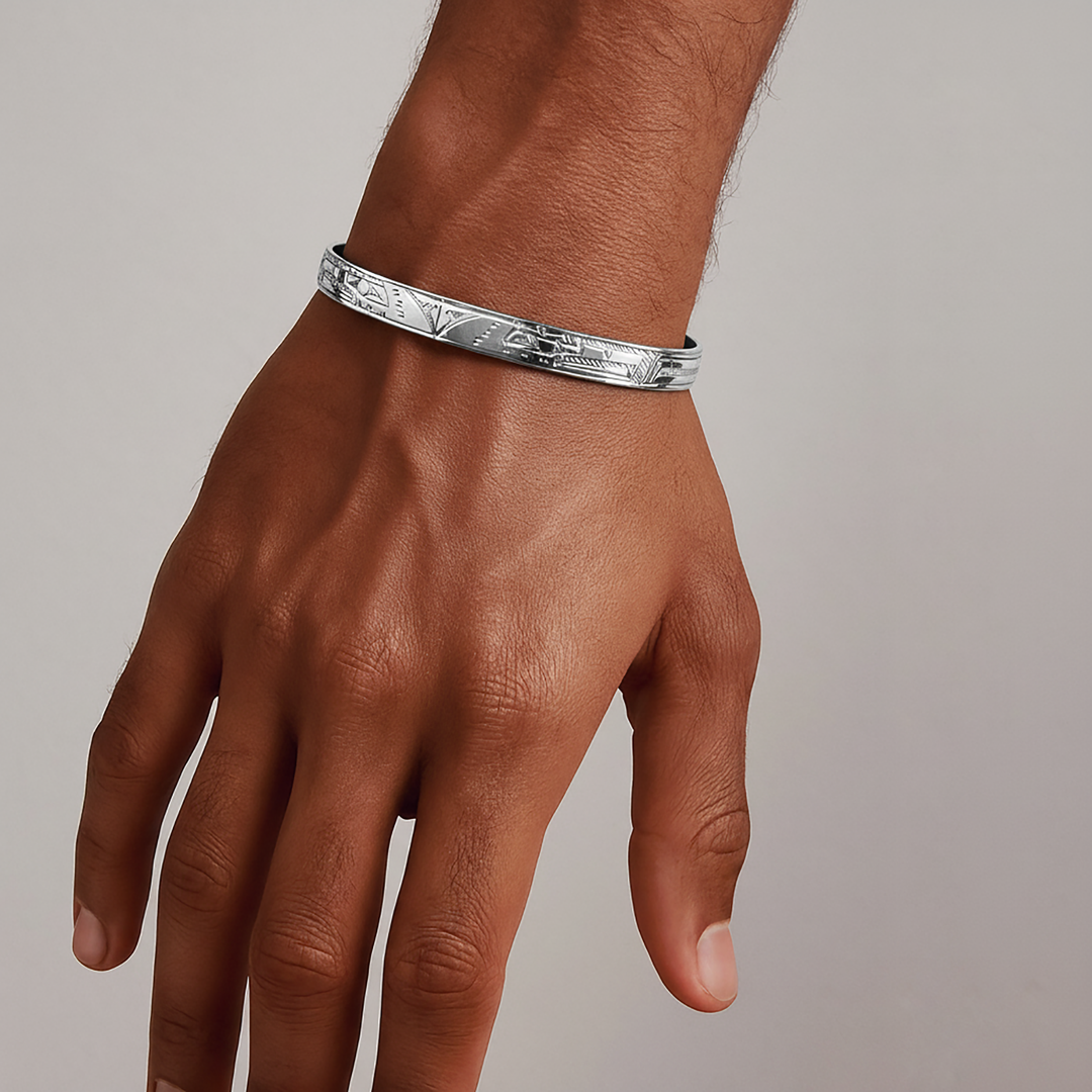 Handmade silver eagle bracelet on a person's wrist against a neutral background.

Double Eagle Clasp Bracelet, two Eagle heads carved indigenous style into this small sterling silver bracelet. 