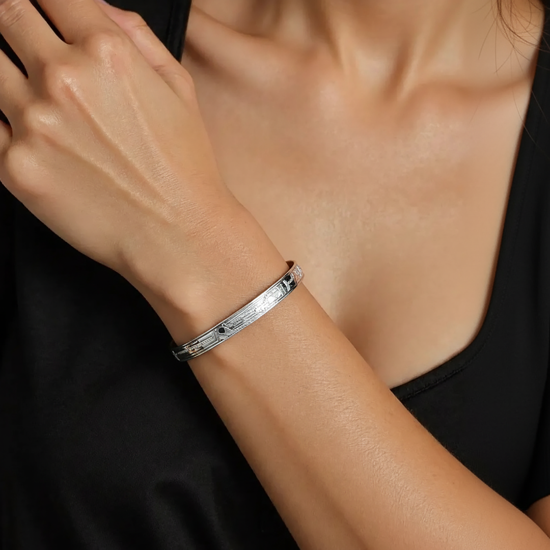 Silver handmade raven bracelet on a person's wrist against a black background.

Sterling Silver Raven Clasp Bracelet