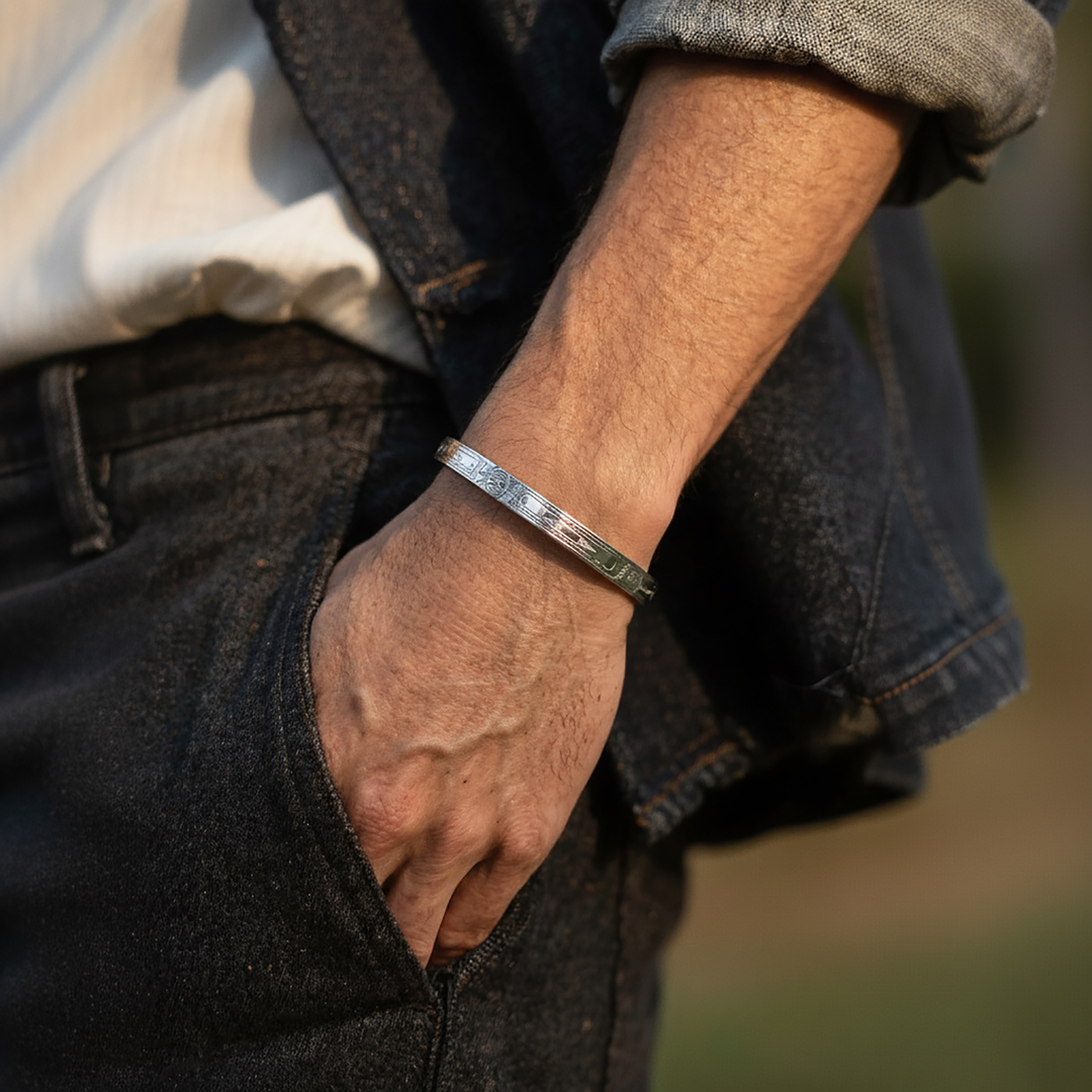 Close-up of a person's arm wearing a silver handmade orca bracelet with a blurred background.

Double Orca with Moon Clasp Bracelet