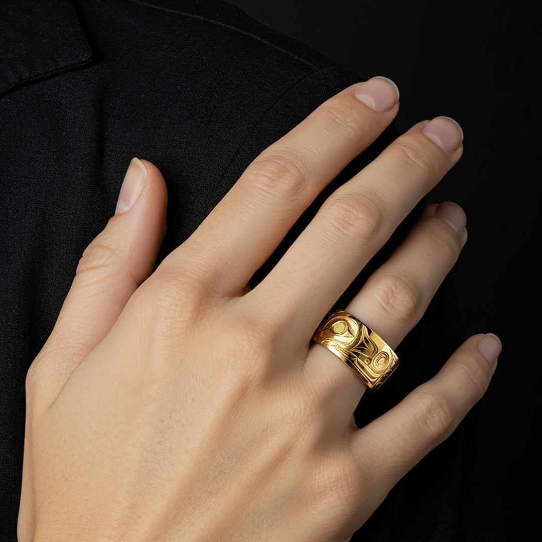 Hand wearing a gold ring with intricate orca hand carved design on a black background.

14K Gold Orca Legend Ring