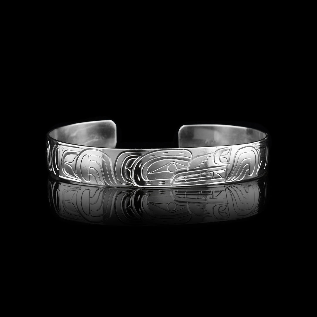 This Wolf cuff bracelet has a thin, sterling silver band with a gap in the back. The head of the Wolf is depicted at a side profile in the center of the band and there are leg designs detailed with claws on either side of the band.