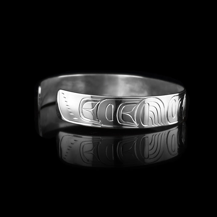 This Wolf cuff bracelet has a thin, sterling silver band with a gap in the back. The head of the Wolf is depicted at a side profile in the center of the band and there are leg designs detailed with claws on either side of the band.