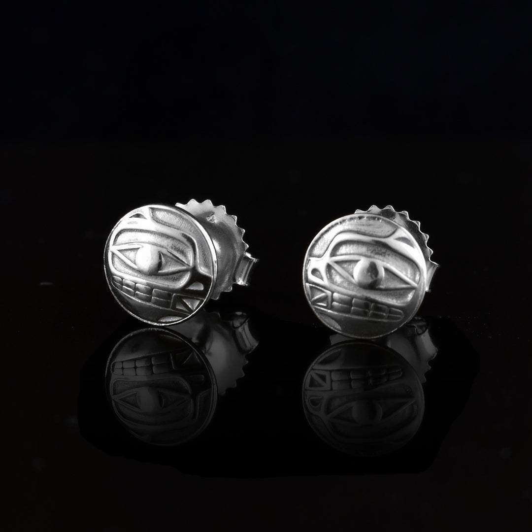 These Bear stud earrings are small and circle shaped and made from sterling silver. There are side profile depictions of the face of the Bear cast into the studs.