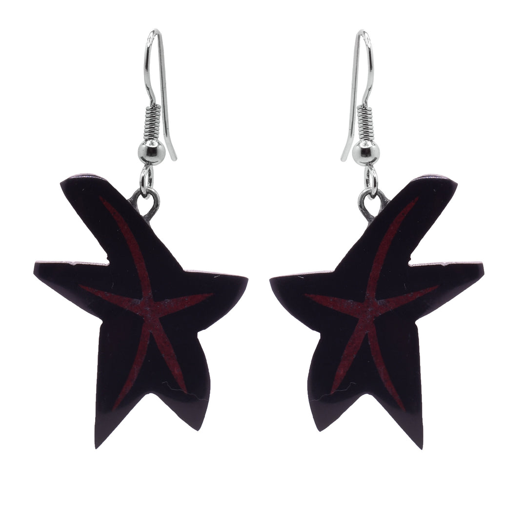These dangling star earrings have star shaped hangs carved from argillite stone. The stars are crudely shaped and there are red designs in the star shape on the hangs.